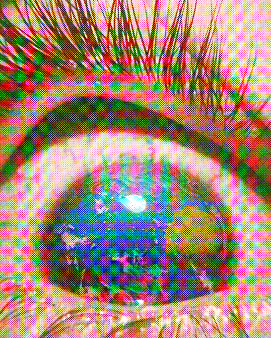 A close up of a person’s eye wide open. Their eyelid and eyelashes are pulled upward. Instead of their iris and pupil, we see the globe of the earth with parts of Africa, Europe and the Americas visible.